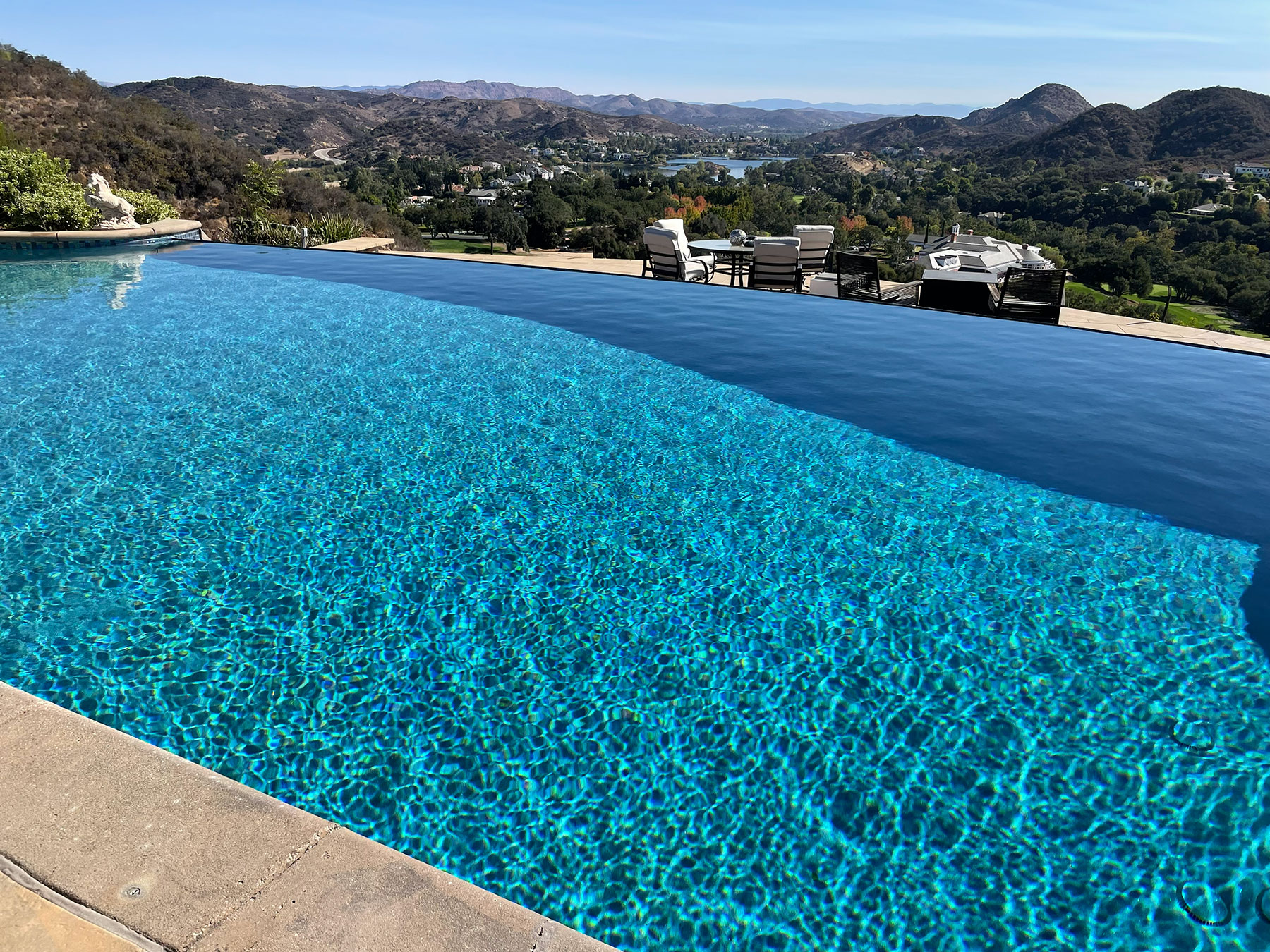 Pool technician cleaning a crystal clear pool